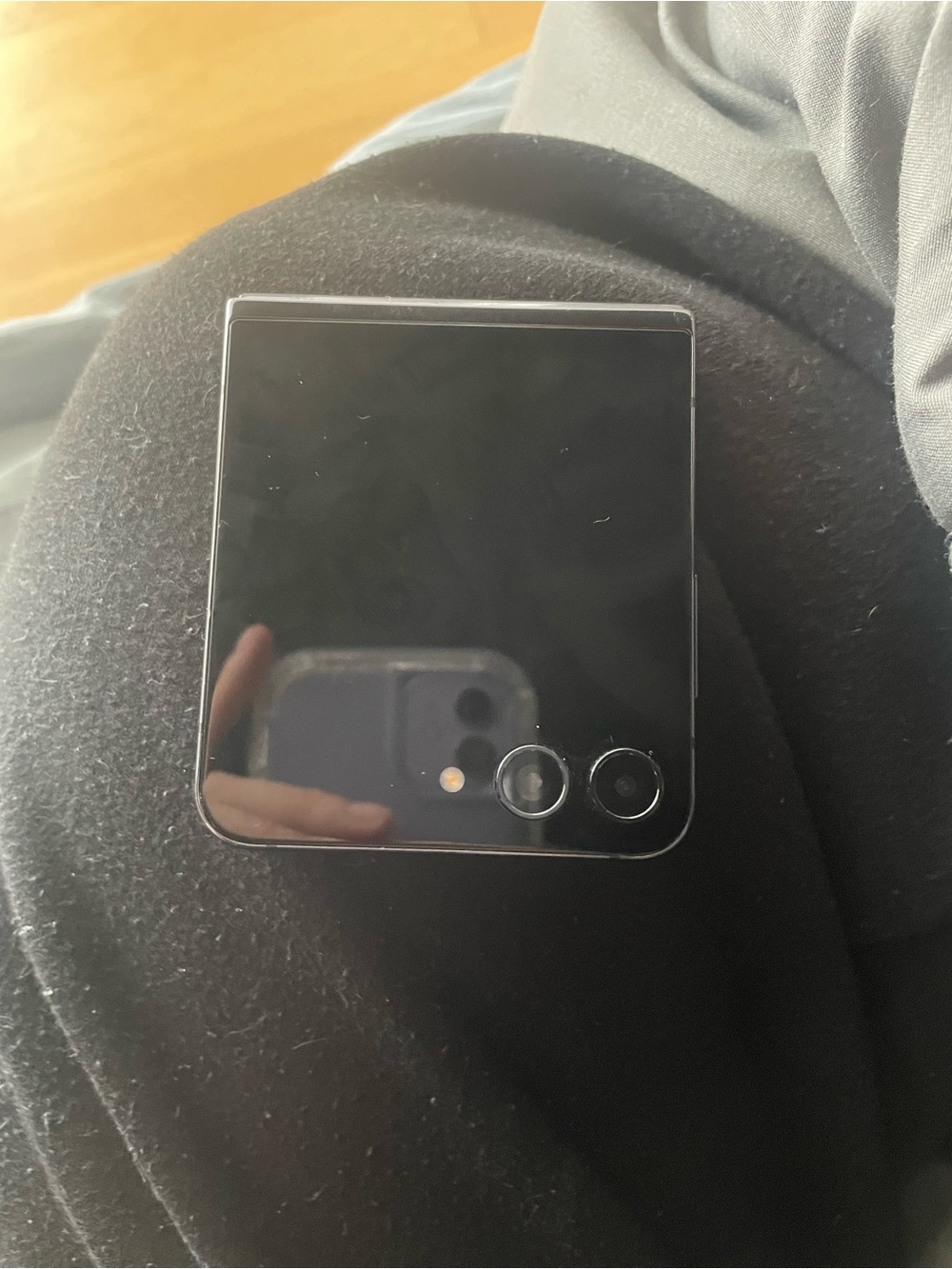 Phone (foldable) photographed — likely not a computer accessory
